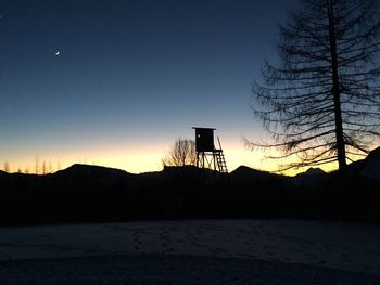 Silhouette landscape against sky during sunset