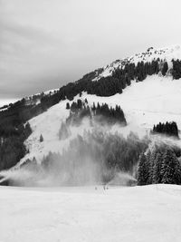 Scenic view of snow covered mountains against sky