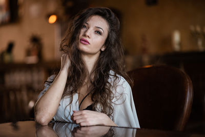 Portrait of young woman sitting outdoors