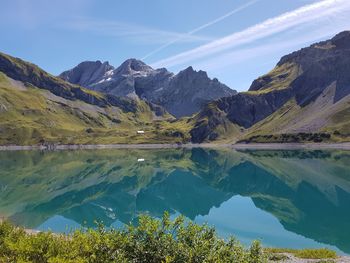 Scenic view of lake and mountains against sky