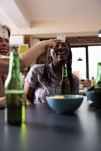 Young woman using mobile phone on table