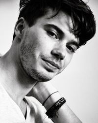 Close-up portrait of young man against white background