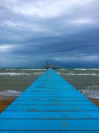 Pier over sea against sky