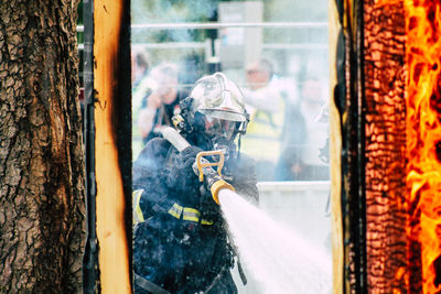 Panoramic shot of man holding umbrella on window