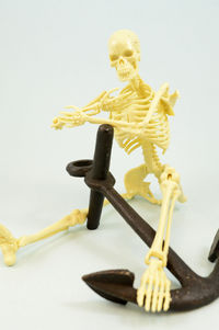 Close-up of figurine on table against white background