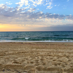 Scenic view of beach against sky during sunset