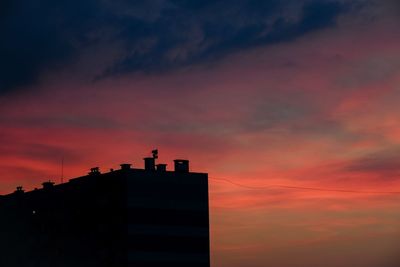 Silhouette building against sky during sunset