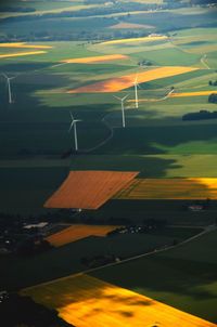 High angle view of wind turbines on patchwork landscape