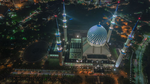 High angle view of city lit up during night