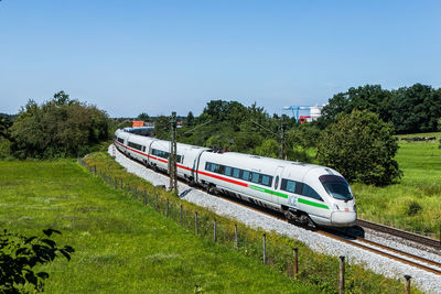 Train on railroad track against clear sky