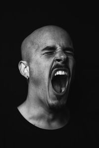 Portrait of man against black background