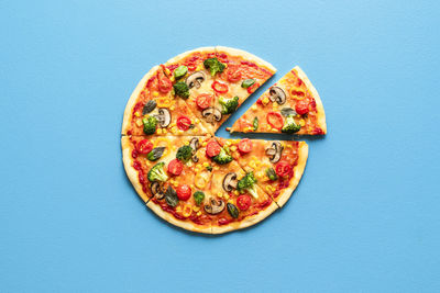 Directly above shot of pizza against blue background