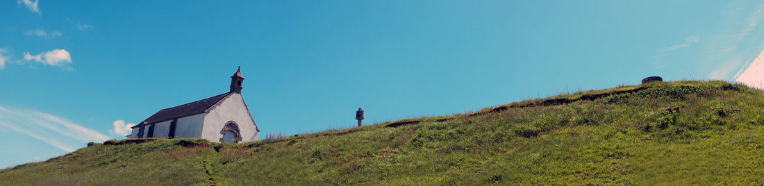 Low angle view of built structure on mountain against clear sky