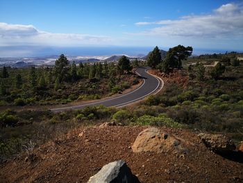 Road passing through mountains against sky