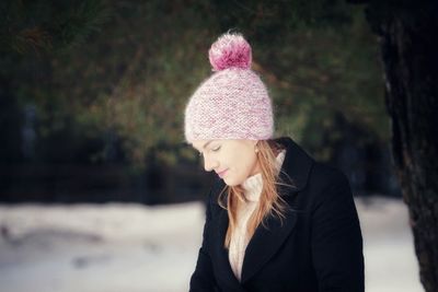 Woman in warm clothing standing outdoors during winter