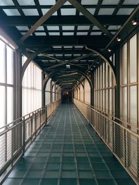 Rear view of people walking on footbridge