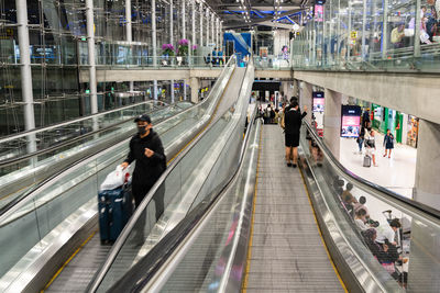 High angle view of people walking on escalator in city