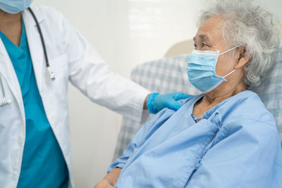 Female doctor examining patient in clinic