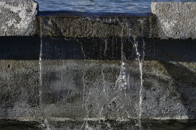 Close-up of water splashing against wall