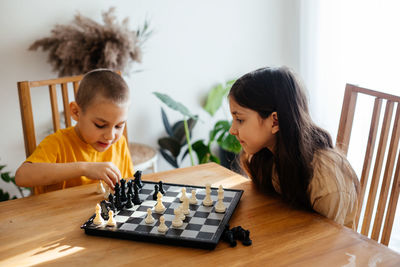 Side view of boys playing on table