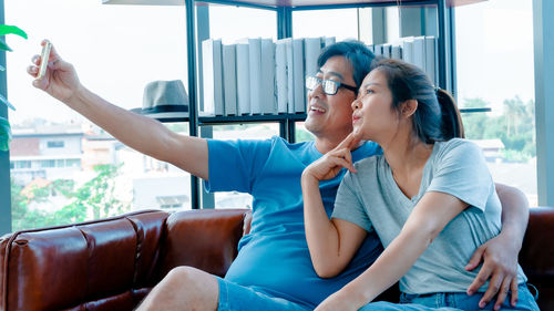 Young couple sitting on floor