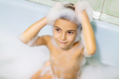 High angle view of shirtless young woman swimming in sink