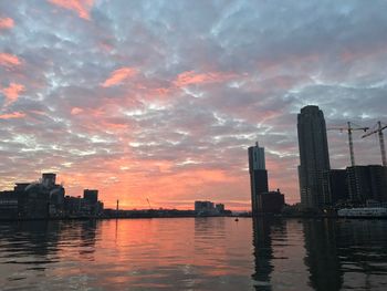 Scenic view of city against sky at sunset