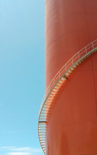 Low angle view of spiral staircase against clear blue sky