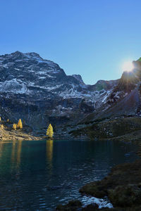 Scenic view of snowcapped mountains against clear sky