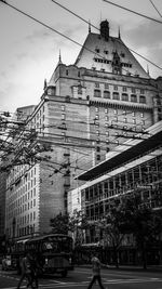 Street by buildings in city against sky