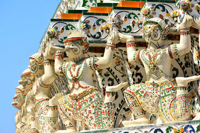 Low angle view of statue against blue sky