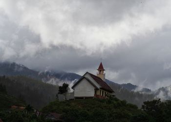 Church with clouds and mountain in background