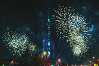 Low angle view of fireworks against sky at night