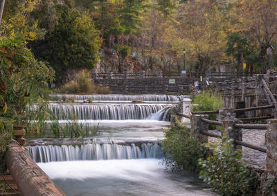 Scenic view of waterfall amidst trees