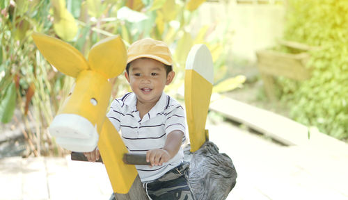 Cute boy sitting on rocking horse