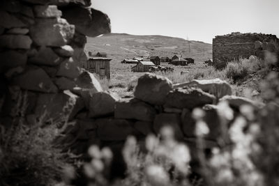 Stone wall of old building against sky