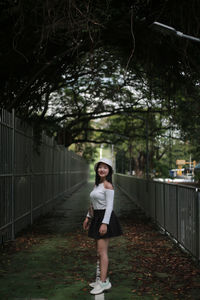 Full length of young woman standing in park