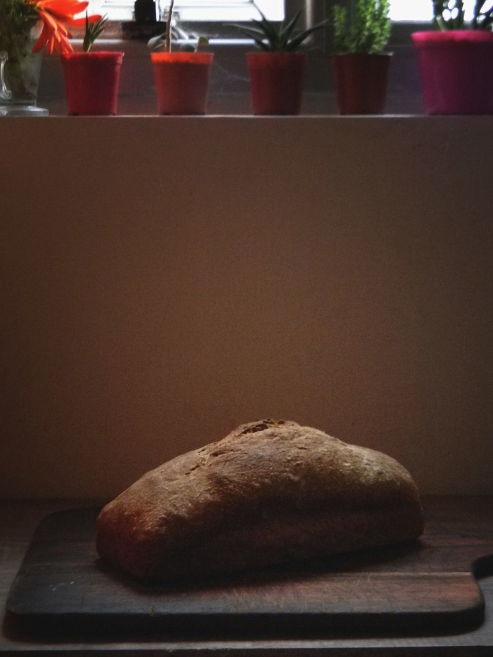 CLOSE-UP OF CAKE ON CUTTING BOARD ON TABLE