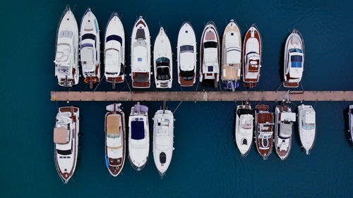 High angle view of sailboats moored in row