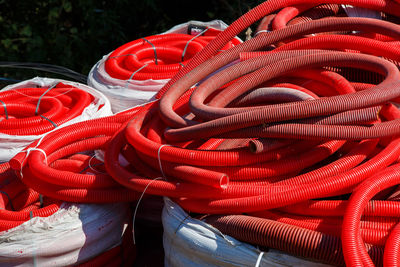 Red corrugated pvc pipes for cable lay on the construction site