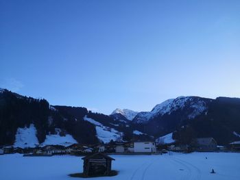 Snow covered mountains against blue sky