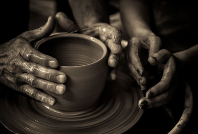 Close-up of man making pottery at workshop