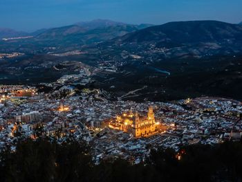 Aerial view of illuminated city at night