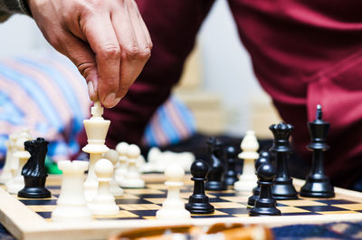 Low angle view of man playing on chess board