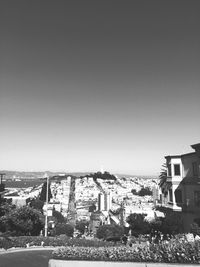 Buildings in city against clear sky