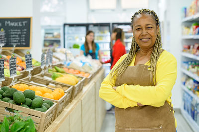 Portrait of smiling woman standing at market