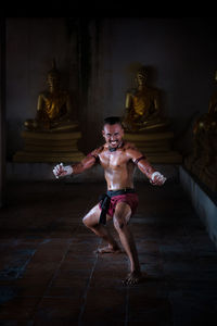 Portrait of shirtless sweaty man exercising