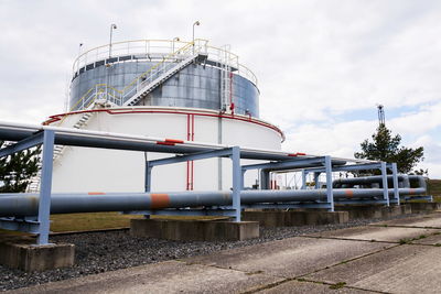 View of factory against cloudy sky