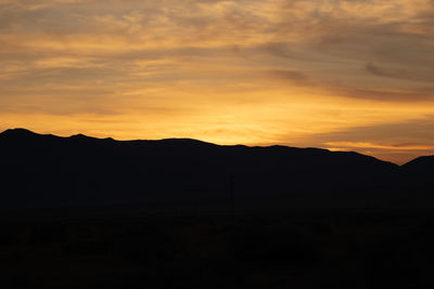 Scenic view of silhouette mountains against sky during sunset