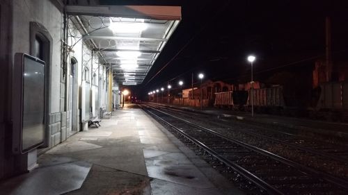 Empty railroad station platform at night